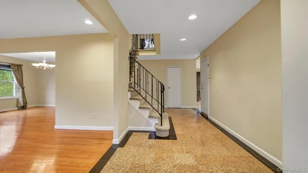 a view of entryway and hall with wooden floor