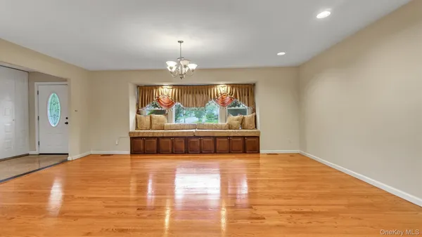 a view of room with window and wooden floor