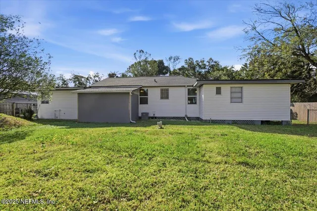 a front view of house with yard and trees