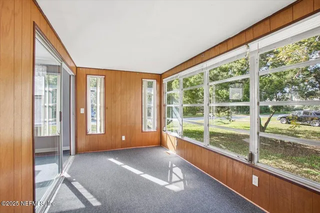 a view of an entryway with wooden floor and windows