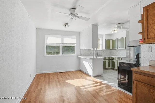 a kitchen with a sink cabinets and window