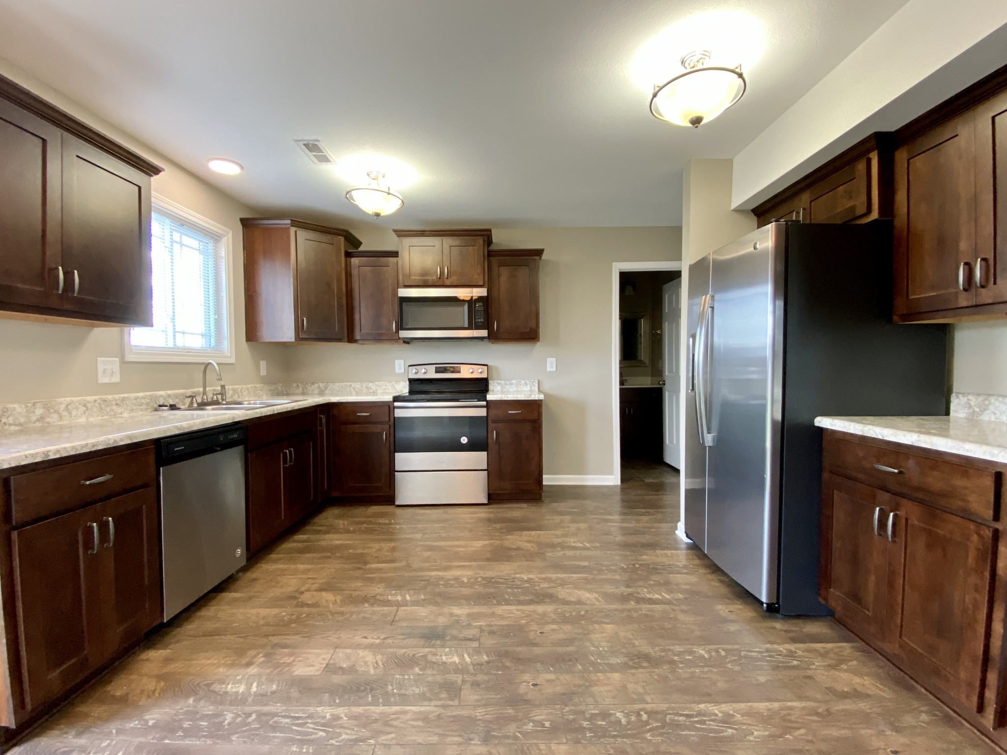 951 Hugh Hunter Road Oak Grove, KY 42262 - Photo 11 of 35 a large kitchen with a large counter top stainless steel appliances and cabinets