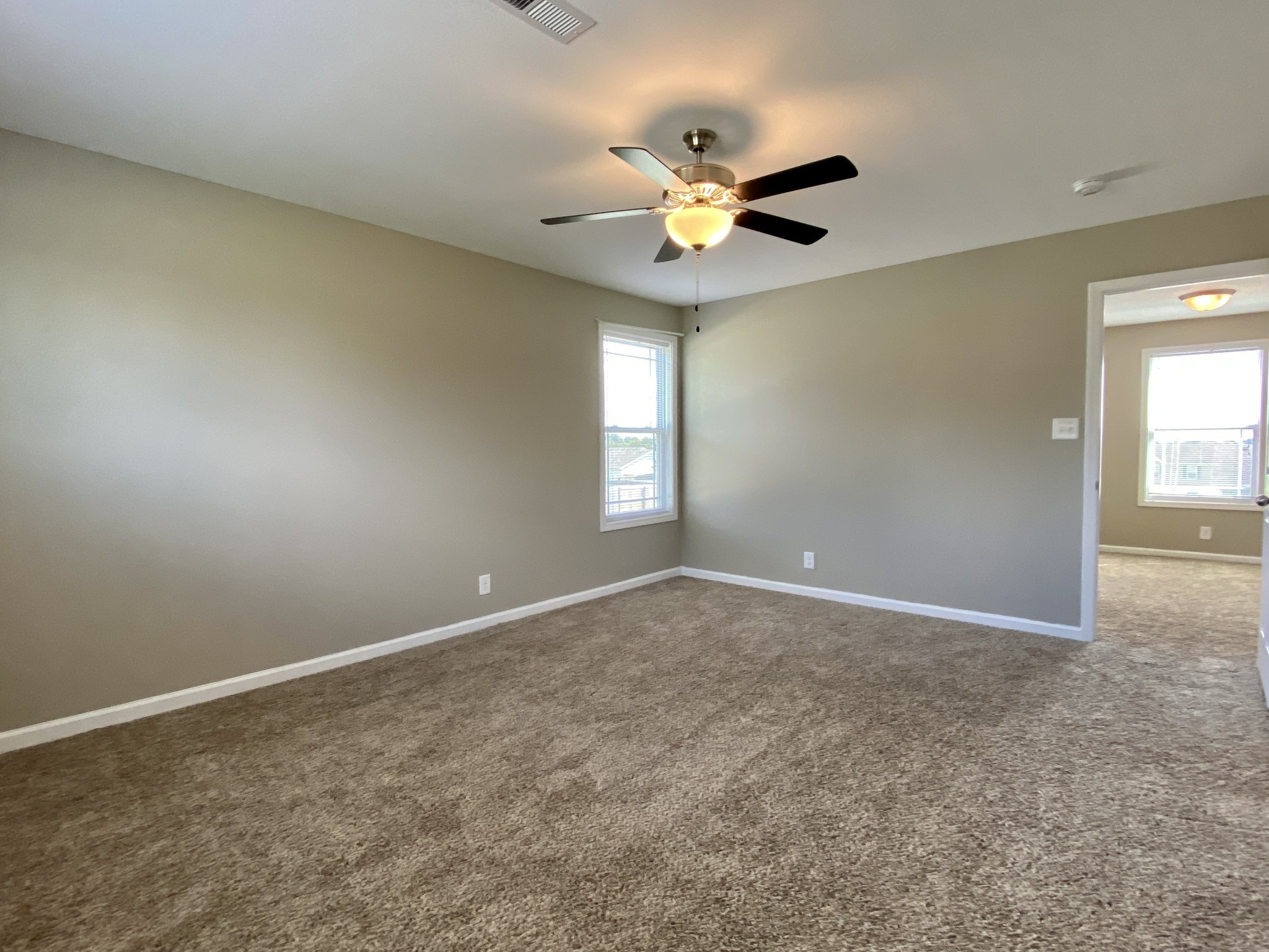 951 Hugh Hunter Road Oak Grove, KY 42262 - Photo 21 of 35 an empty room with windows and fan