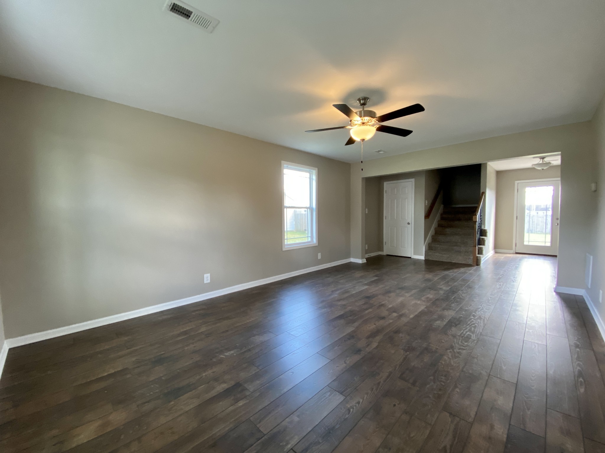 951 Hugh Hunter Road Oak Grove, KY 42262 - Photo 4 of 35 an empty room with wooden floor and a ceiling fan