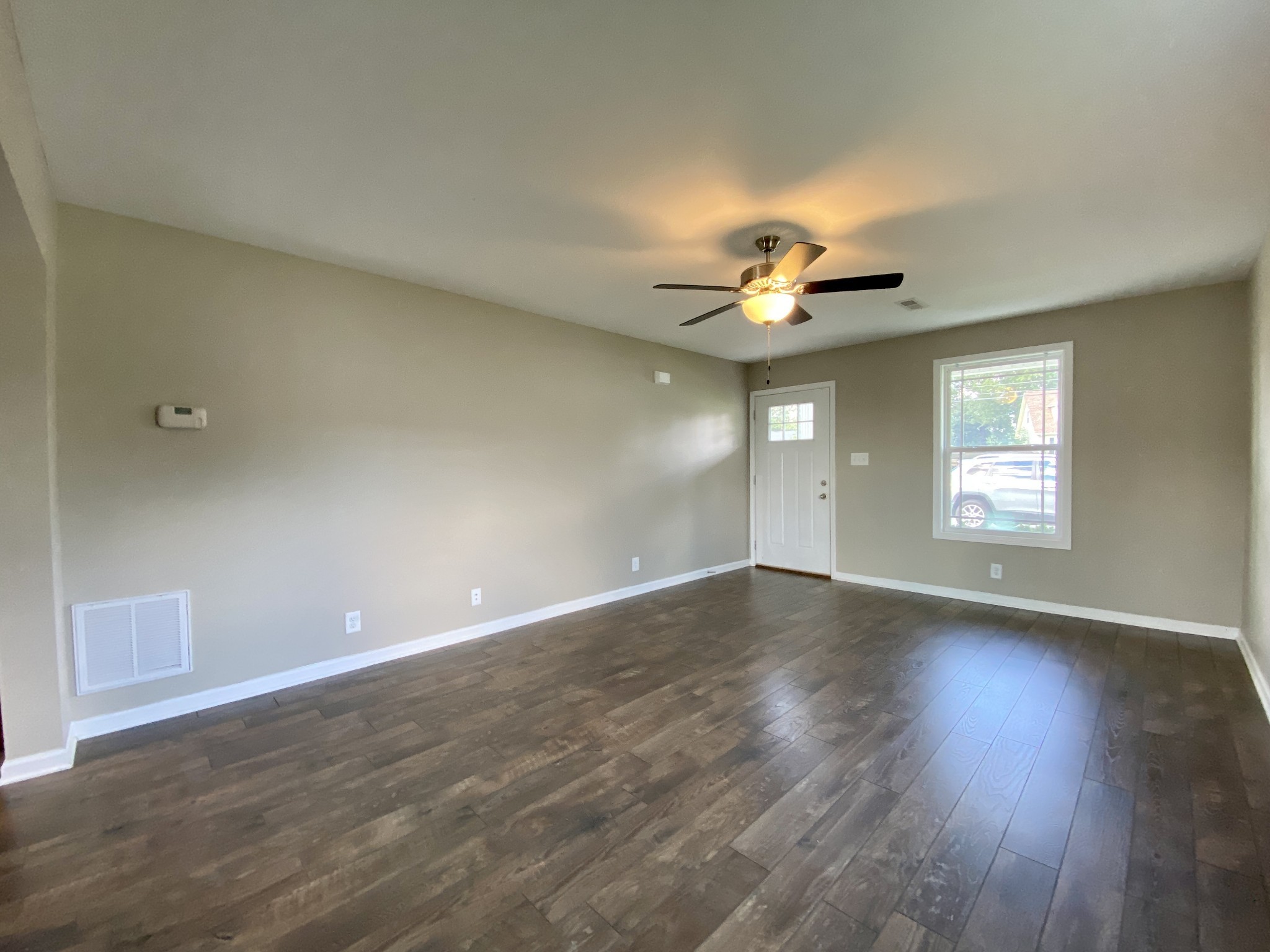 951 Hugh Hunter Road Oak Grove, KY 42262 - Photo 6 of 35 a view of an empty room with a window and wooden floor