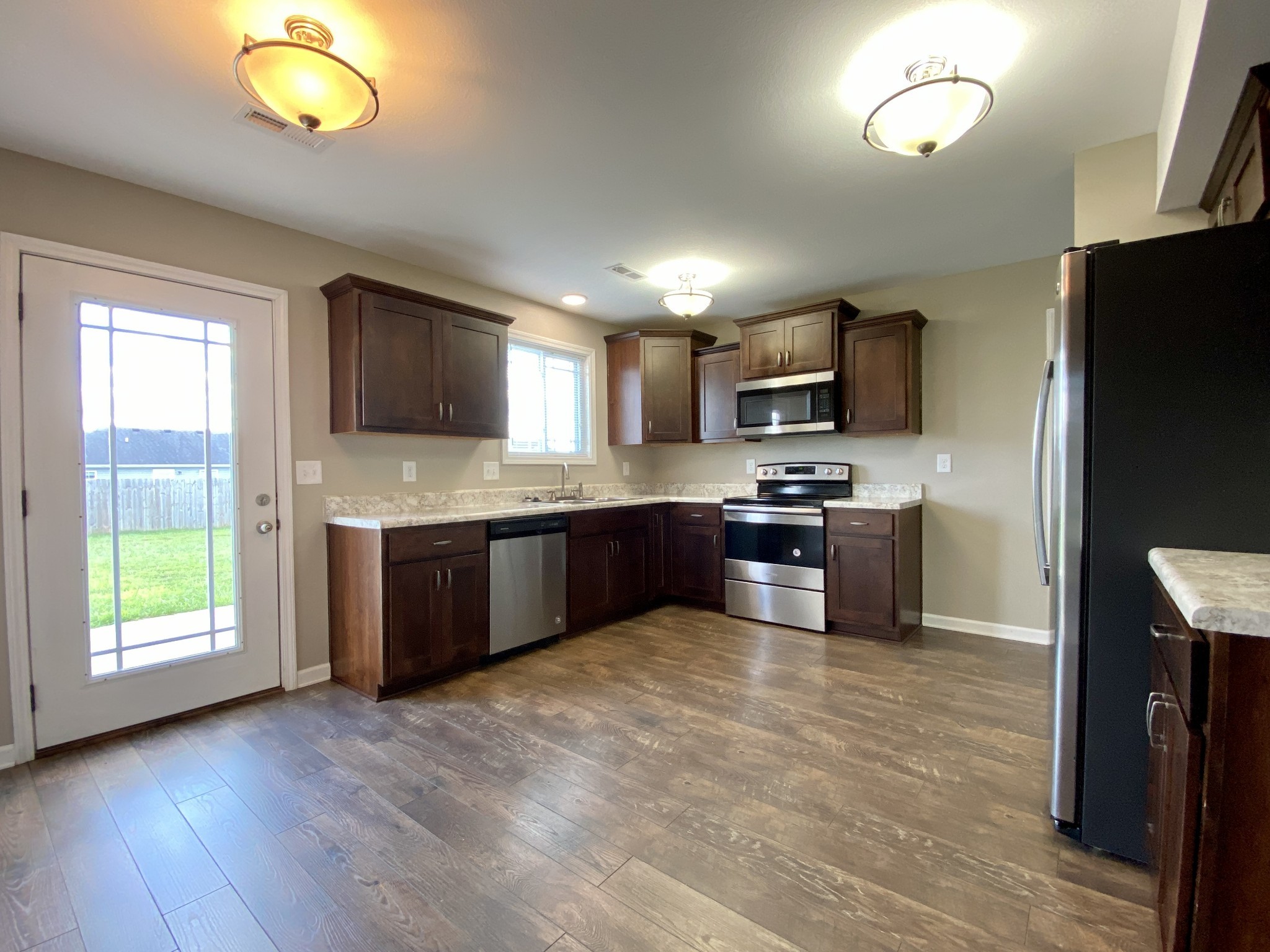 951 Hugh Hunter Road Oak Grove, KY 42262 - Photo 10 of 35 a kitchen with granite countertop a stove and a microwave