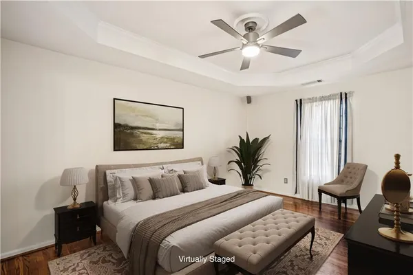 a bedroom with bed and a potted plant