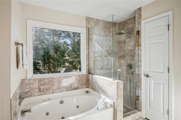 a bathroom with a bathtub and shower