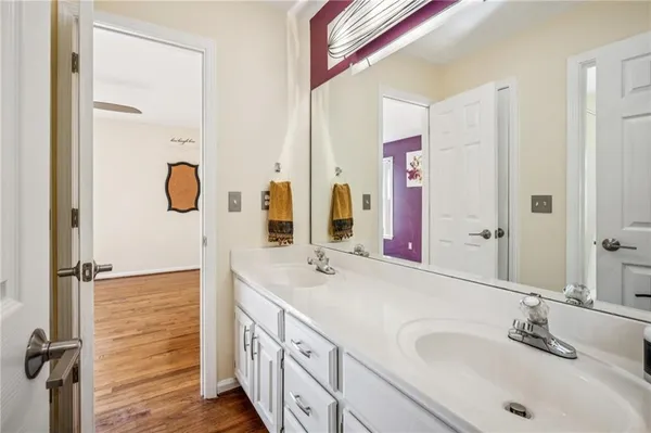 a bathroom with a double vanity sink a mirror and shower