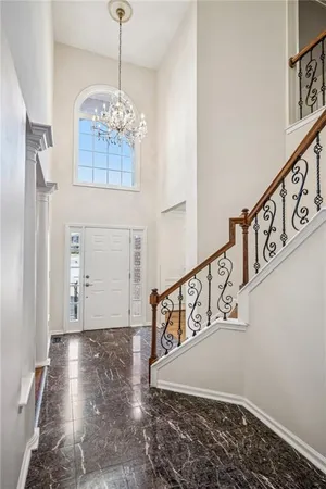 a view of entryway and hall with wooden floor
