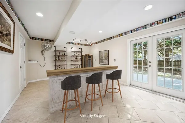 a living room with furniture and large windows