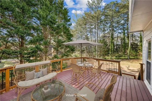 a balcony with wooden floor and furniture
