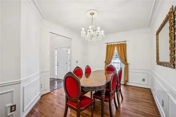 a view of a dining room with furniture and chandelier