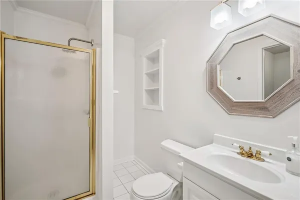 a bathroom with a sink vanity mirror and toilet