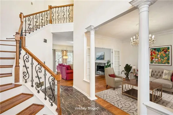 a view of entryway and hall with wooden floor