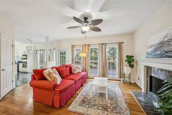 a living room with furniture a fireplace and a chandelier