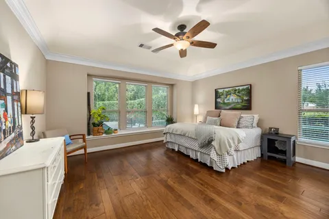 a spacious bedroom with a large bed and a large window