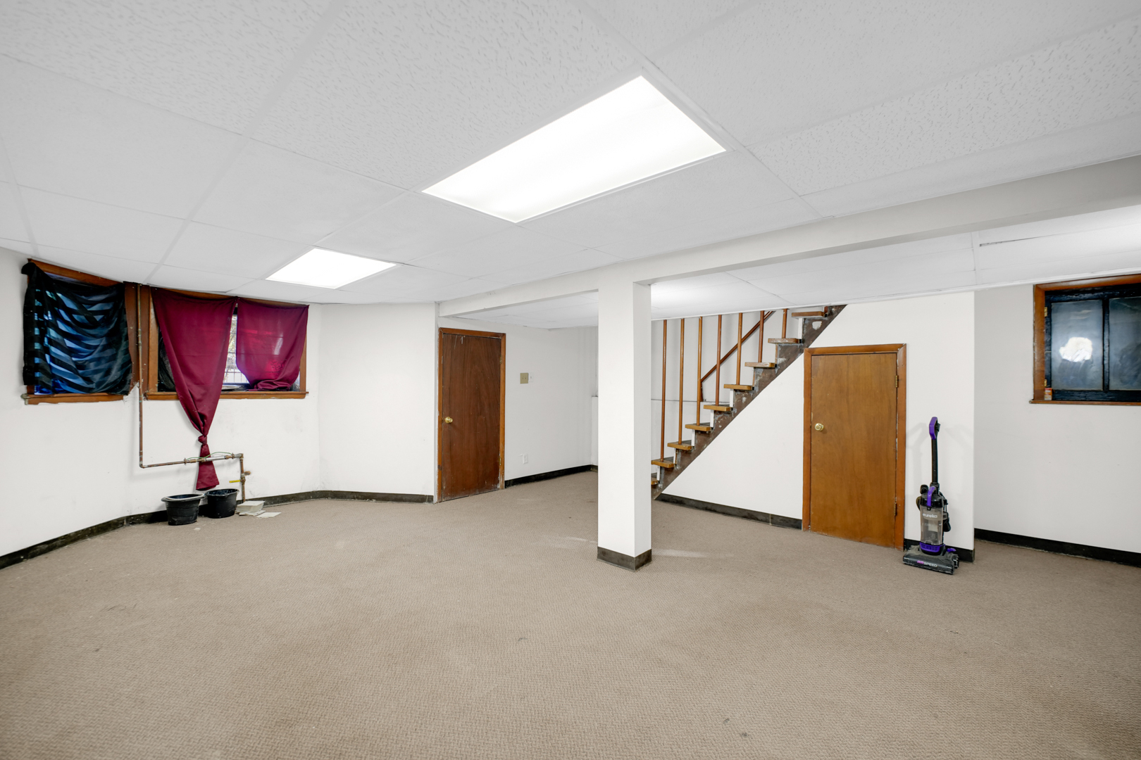 6045 South Peoria Street Chicago, IL 60621 - Photo 14 of 25 a view of an empty room with wooden floor and windows