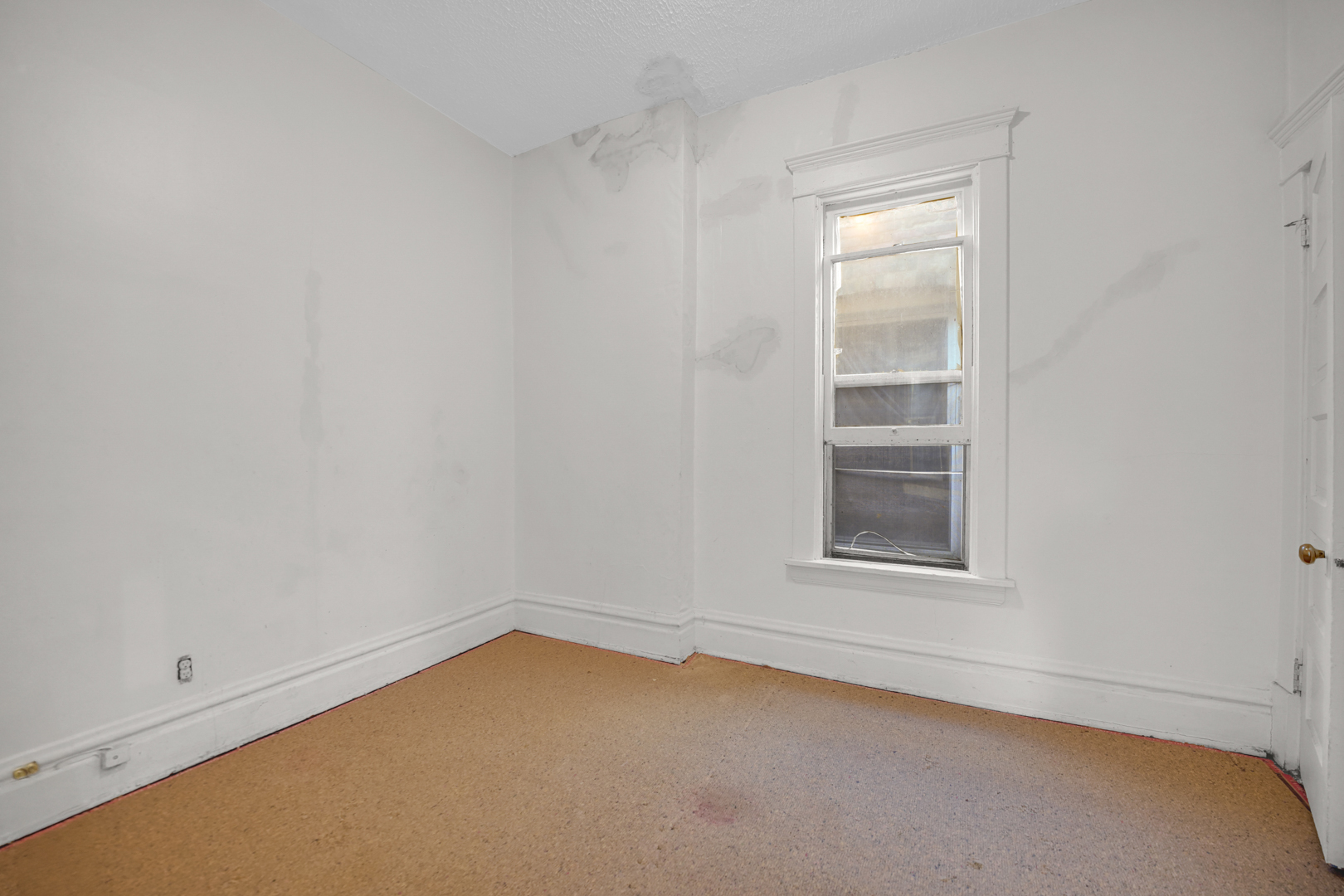 6045 South Peoria Street Chicago, IL 60621 - Photo 15 of 25 an empty room with a window