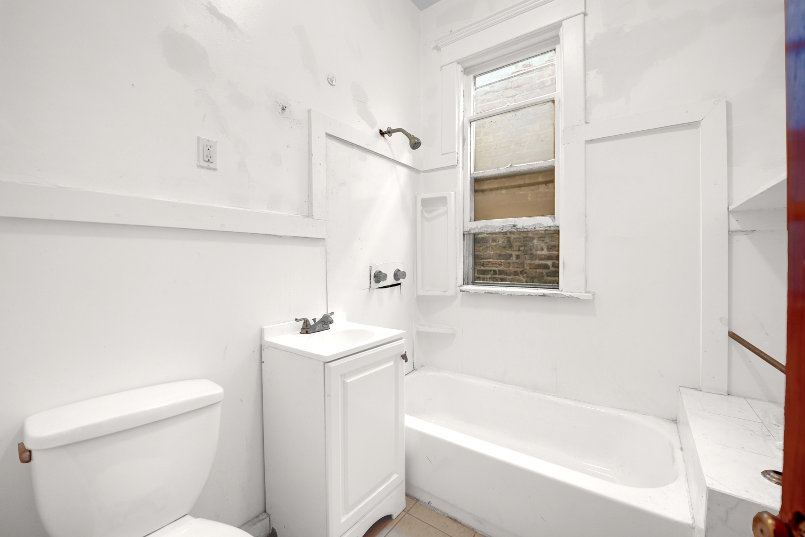 6045 South Peoria Street Chicago, IL 60621 - Photo 16 of 25 a white bath tub sitting next to a white toilet and sink