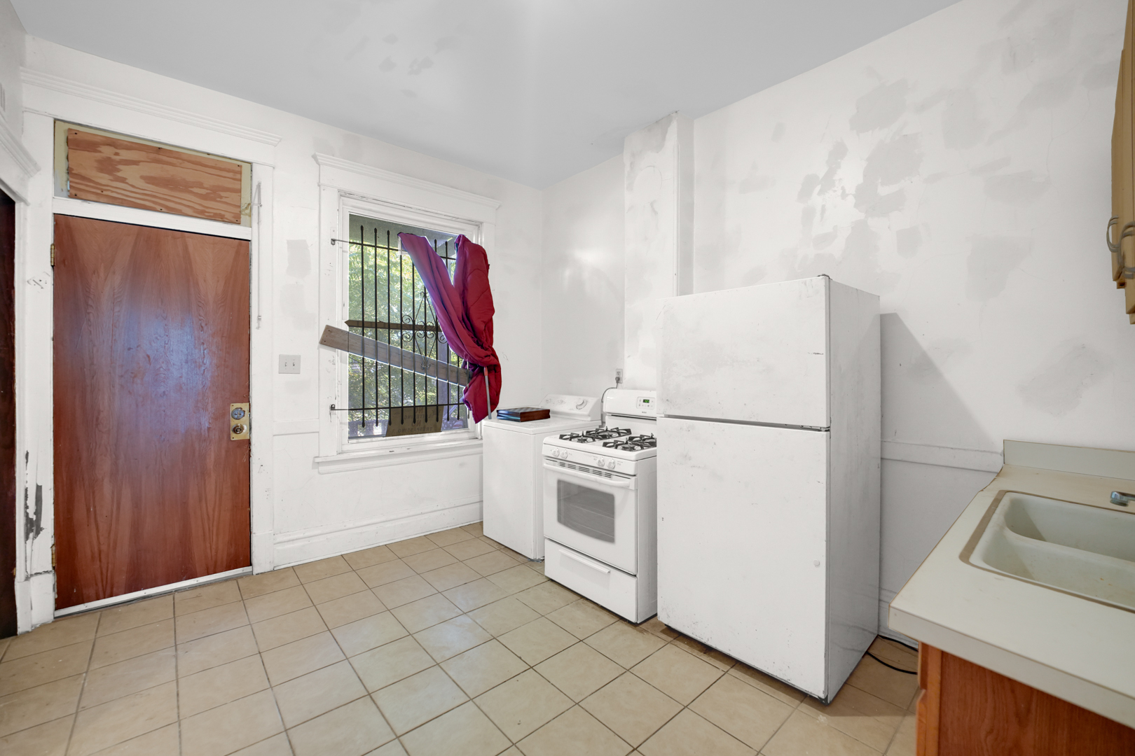 6045 South Peoria Street Chicago, IL 60621 - Photo 17 of 25 a kitchen with a white cabinets and white appliances