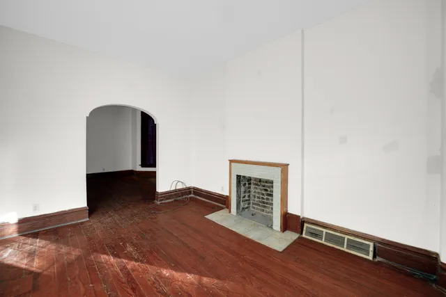 a view of a livingroom with wooden floor and window