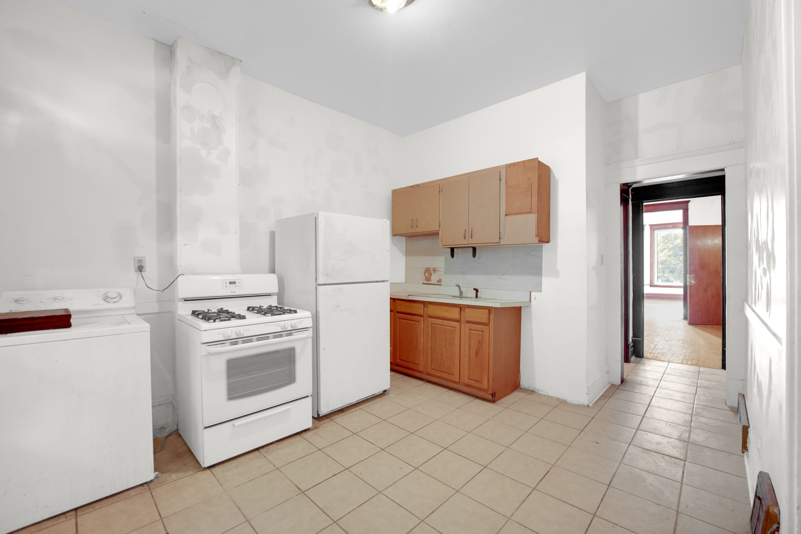 6045 South Peoria Street Chicago, IL 60621 - Photo 22 of 25 a kitchen with a stove top oven and cabinets