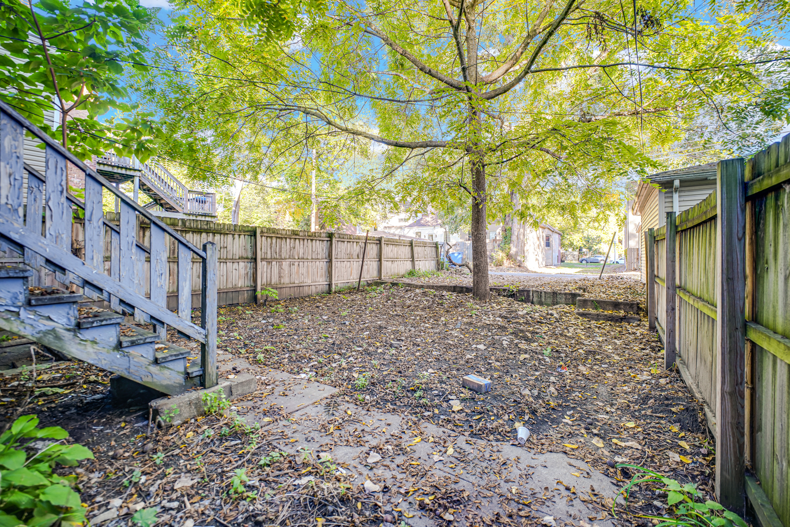 6045 South Peoria Street Chicago, IL 60621 - Photo 5 of 25 a view of a yard with plants and wooden fence