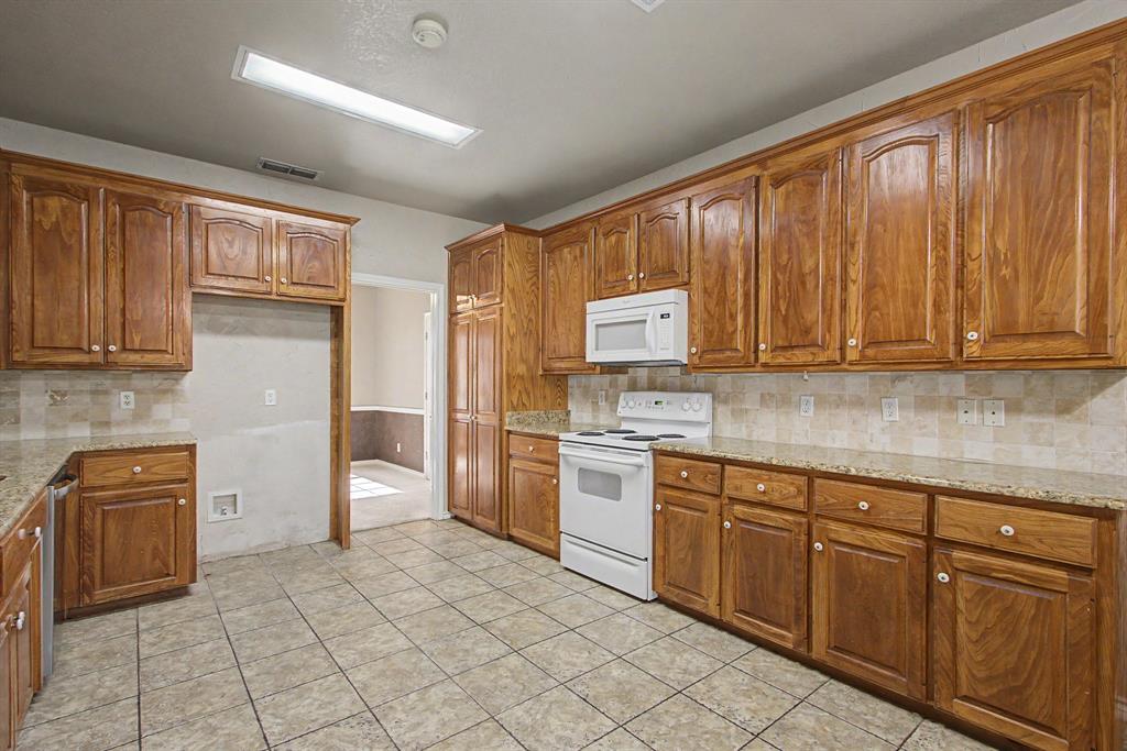 483 Christy Kay Lane Rhome, TX 76078 - Photo 12 of 40 a kitchen with stainless steel appliances granite countertop a refrigerator and sink