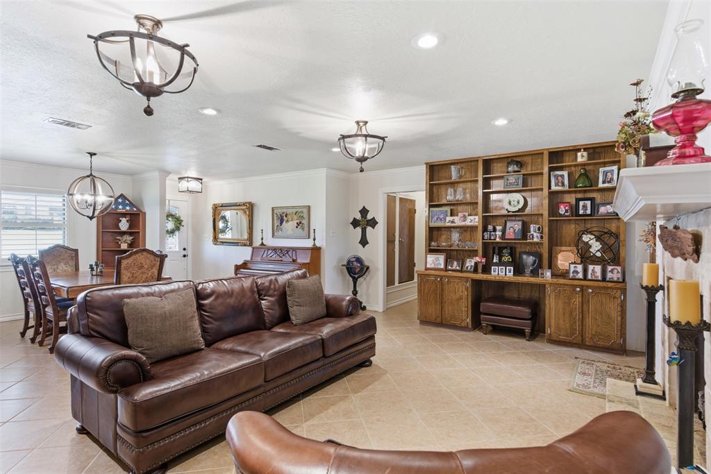 116 Cromeans Street Jacksboro, TX 76458 - Photo 11 of 32 a living room with furniture a chandelier and a dining table