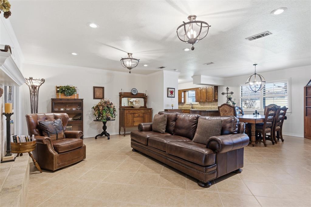116 Cromeans Street Jacksboro, TX 76458 - Photo 12 of 32 a living room with furniture kitchen view and a chandelier