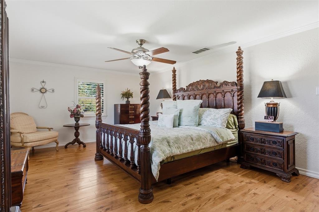 116 Cromeans Street Jacksboro, TX 76458 - Photo 17 of 32 a spacious bedroom with a bed a chandelier and a couch