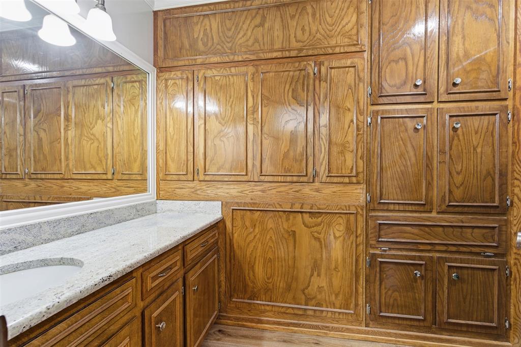 116 Cromeans Street Jacksboro, TX 76458 - Photo 21 of 32 a bathroom with granite countertop a sink and a shower