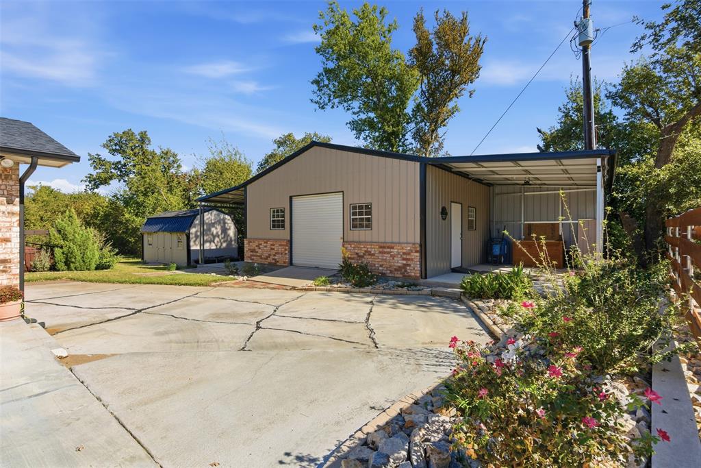 116 Cromeans Street Jacksboro, TX 76458 - Photo 27 of 32 a front view of a house with a yard and garage