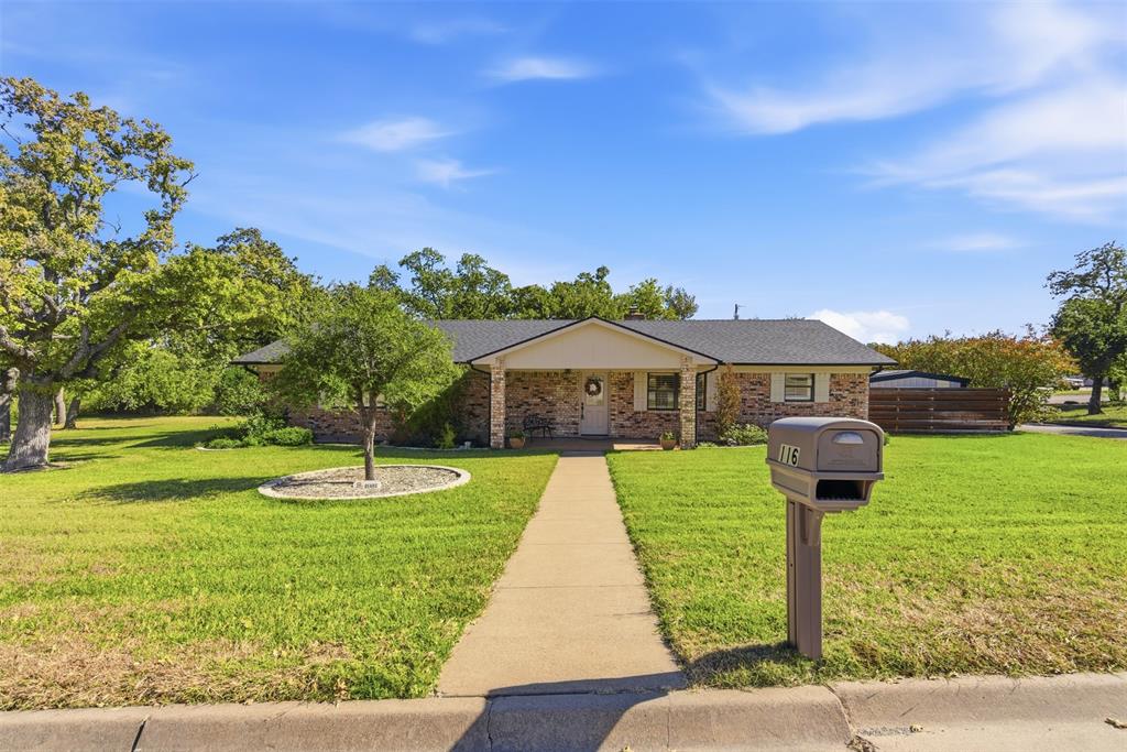116 Cromeans Street Jacksboro, TX 76458 - Photo 4 of 32 a front view of a house with garden