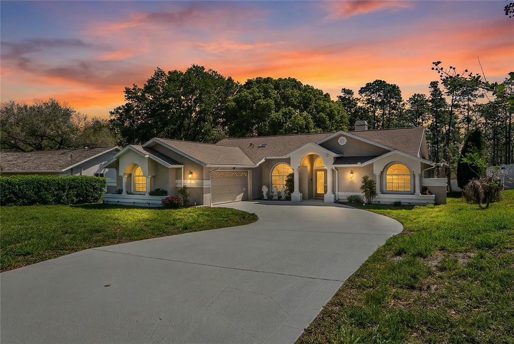 6324 India Drive Spring Hill, FL 34608 - Photo 1 of 68 a front view of a house with a yard and garage