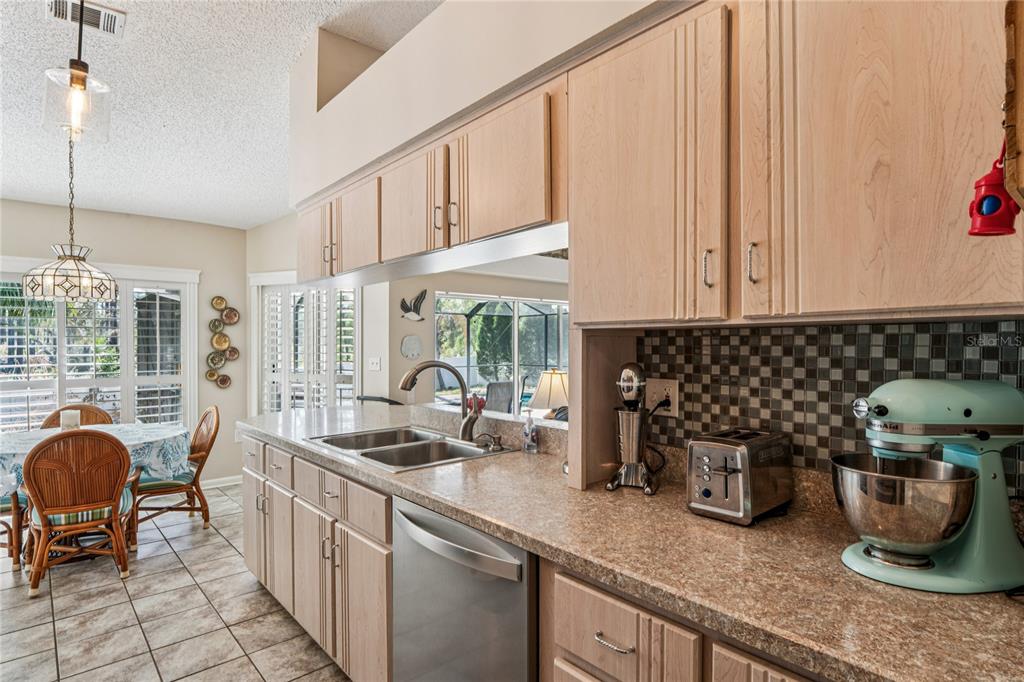 6324 India Drive Spring Hill, FL 34608 - Photo 17 of 68 a kitchen with sink a window and cabinets