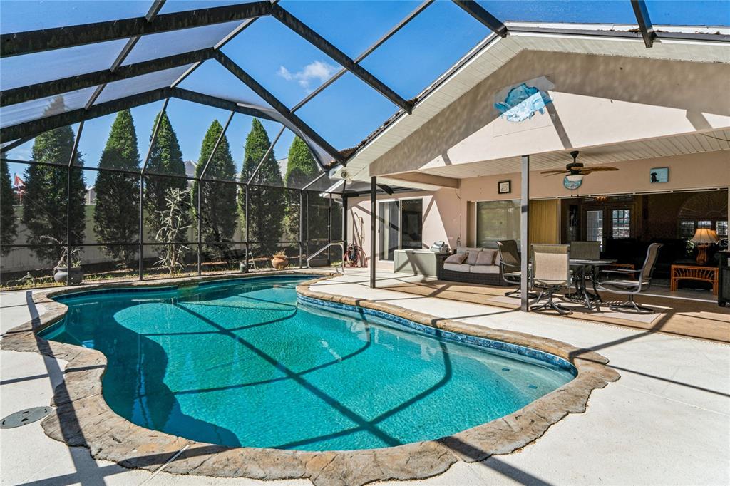 6324 India Drive Spring Hill, FL 34608 - Photo 2 of 68 a view of a swimming pool with chairs and tables