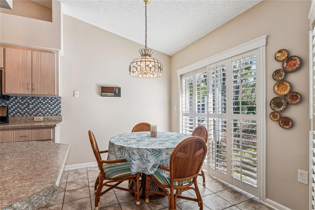 6324 India Drive Spring Hill, FL 34608 - Photo 21 of 68 a dining room with furniture and wooden floor