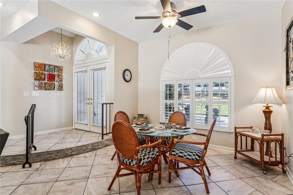 6324 India Drive Spring Hill, FL 34608 - Photo 24 of 68 a dining room with furniture a chandelier and a rug