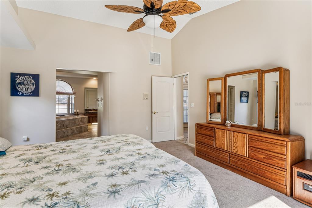 6324 India Drive Spring Hill, FL 34608 - Photo 29 of 68 a bedroom with a bed and a large mirror on the dresser