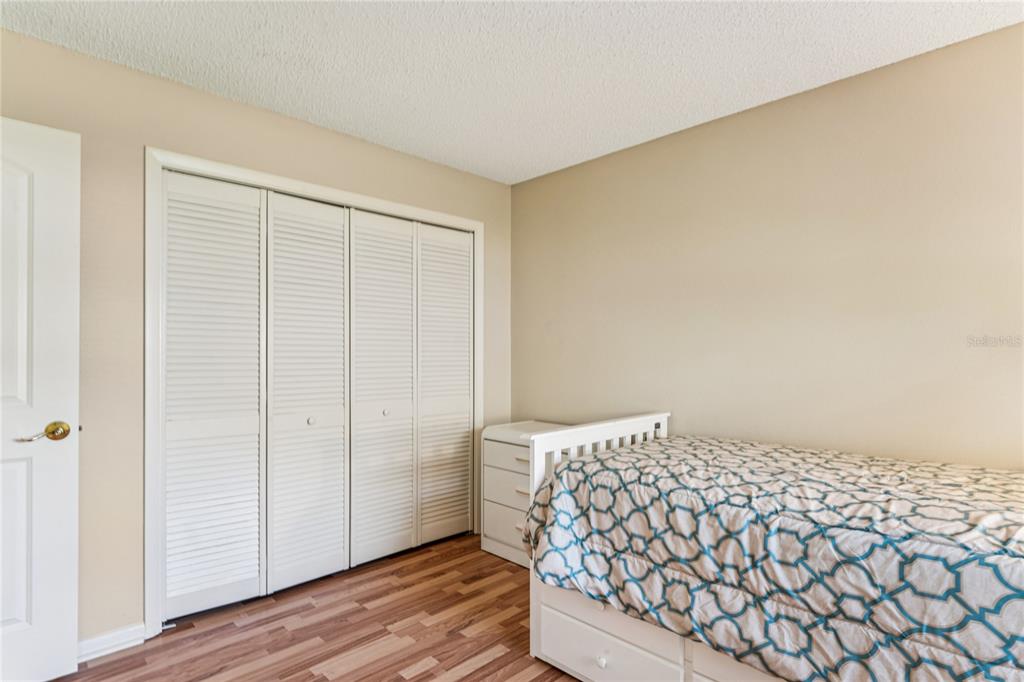 6324 India Drive Spring Hill, FL 34608 - Photo 37 of 68 a bedroom with a bed and wooden floor