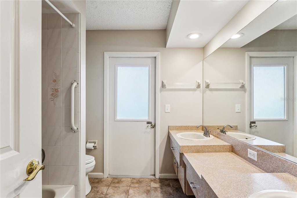 6324 India Drive Spring Hill, FL 34608 - Photo 39 of 68 a bathroom with a sink and mirror with toilet