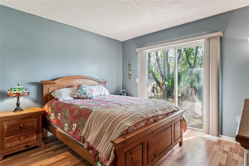 6324 India Drive Spring Hill, FL 34608 - Photo 41 of 68 a bedroom with a bed and wooden floor