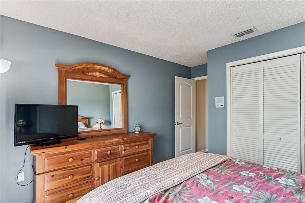 6324 India Drive Spring Hill, FL 34608 - Photo 43 of 68 a bedroom with a bed and a flat screen tv