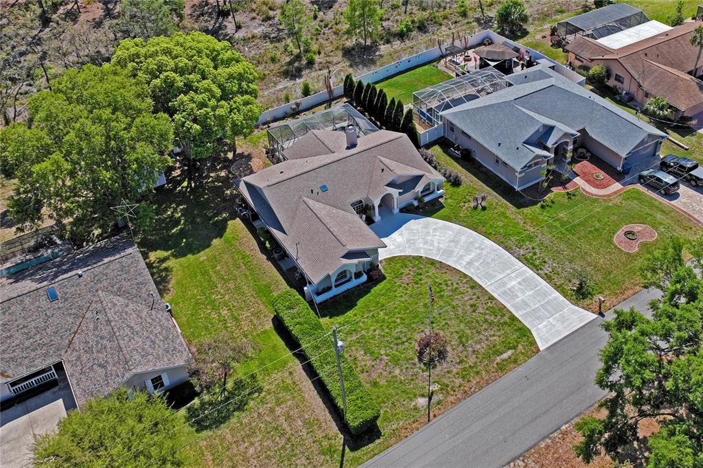 6324 India Drive Spring Hill, FL 34608 - Photo 62 of 68 an aerial view of a house with a garden and lake view