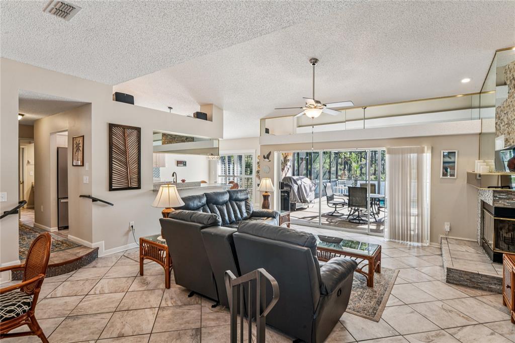 6324 India Drive Spring Hill, FL 34608 - Photo 7 of 68 a living room with furniture a flat screen tv and a large window