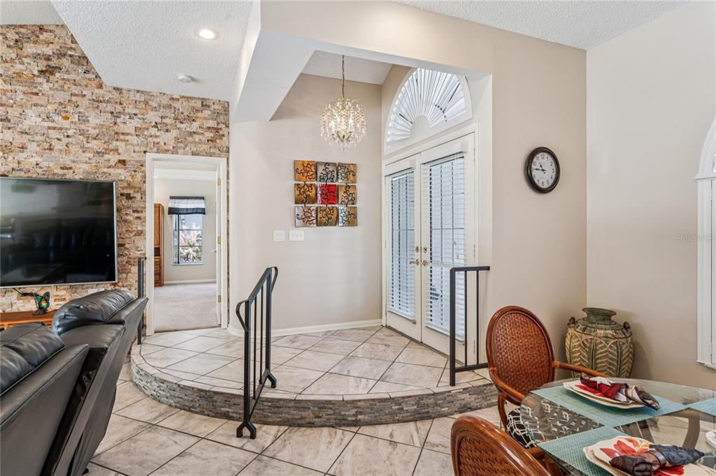 6324 India Drive Spring Hill, FL 34608 - Photo 8 of 68 a living room with furniture a flat screen tv and kitchen view