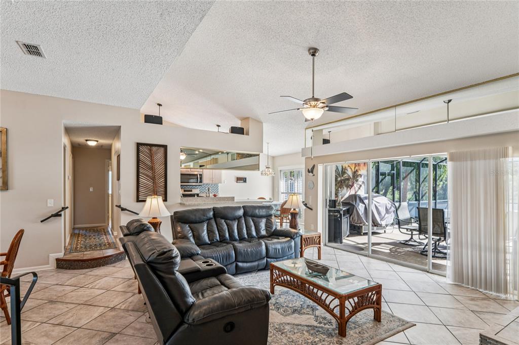 6324 India Drive Spring Hill, FL 34608 - Photo 10 of 68 a living room with furniture a large window and a chandelier