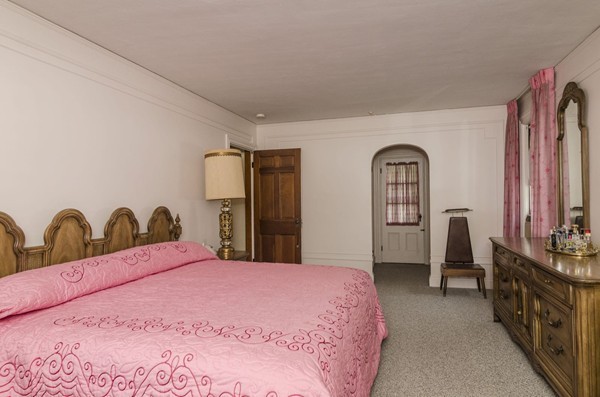 348 Russett Road Brookline, MA 02467 - Photo 12 of 18 a bedroom with a bed and a large mirror on dresser